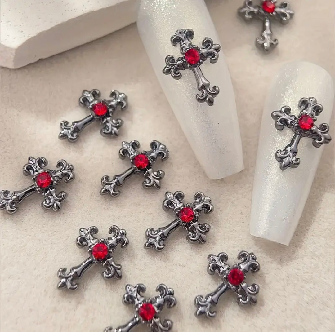 Amuletos de uñas en forma de cruz