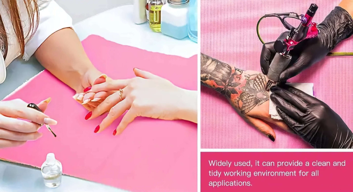 Two hands on pink disposable table mat, one getting a manicure and the other a tattoo, highlighting versatility and cleanliness.